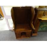 A rustic walnut lambing chair with dog kennel beneath