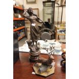 Two spelter figures, one of a fisher women with net and fish, other of leaping stag