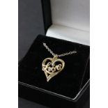 A 10ct yellow gold heart shaped diamond set pendant necklace