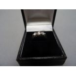 An 18ct white gold three stone diamond ring of 85 points