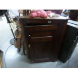 A 19th century mahogany corner cupboard with shelved interior.