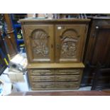 Oak Cupboard with Tavern Scene Relief Carved Doors together with Oak Chest of Six Short Drawers