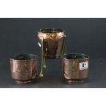 Arts and Crafts Copper Rocket Shaped Bowl on Three Brass Legs together with a Pair of Arts and