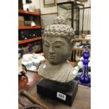 Stone carved bust of Egyptian Goddess on wooden plinth