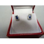A pair of 9ct white gold, sapphire and diamond earrings, total weight 1ct