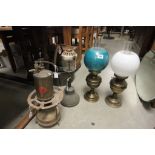 Three vintage oil lamps with shades, primus stove and blow torch