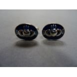 A pair of silver and enamel cufflinks