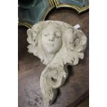 Reconstituted stone wall pocket of ladies face addorned with flowers