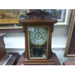An antique Jerome and Co gingerbread style pine cased clock.