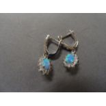 A pair of silver, cz and blue opal earrings