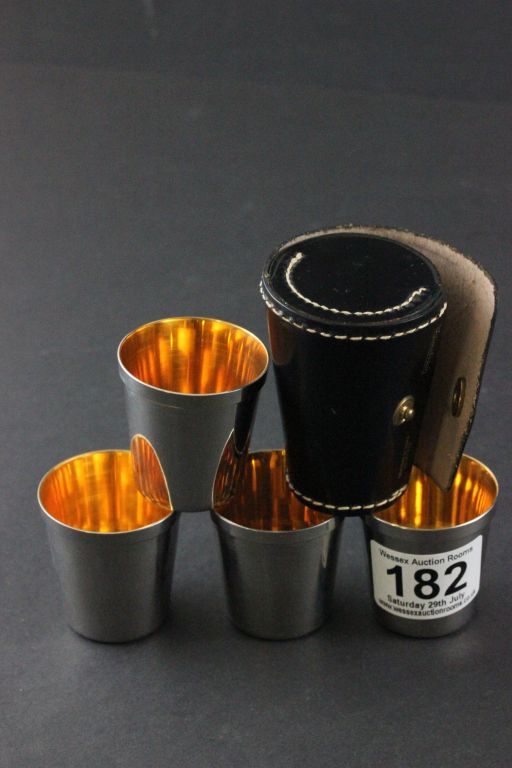 Set of Four Hunting Stacking Silver Plate Stirrup Cups with Gilt Linings contained in a Black