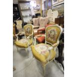 A pair of painted French salon armchairs with woolwork floral upholstery.