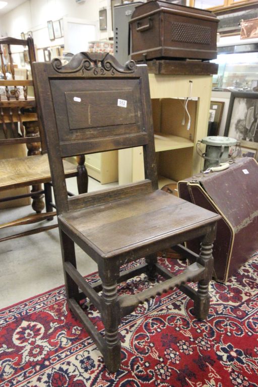 An antique oak 17th century style chair the back support carved with the date 1625 ?.