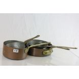 Five vintage copper saucepans with brass handles