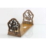 Black Forest Early 20th century Oak Bookslide, the supports with pierced floral carving