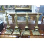 Group of four Corinthian Column style brass lamps wired for electric