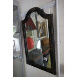 An antique chinoiserie serpentine topped mirror.