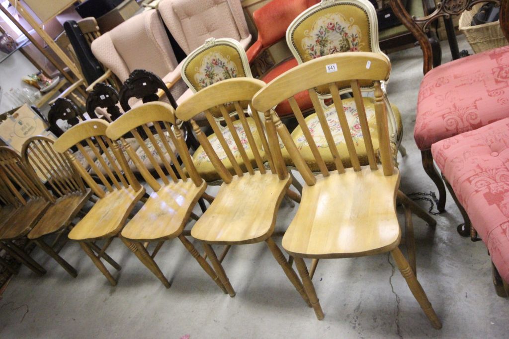 A set of four beech slat back farmhouse style kitchen chairs.