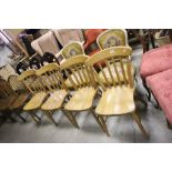 A set of four beech slat back farmhouse style kitchen chairs.