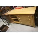 A contemporary four drawer pine sideboard.