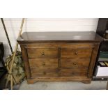 A contemporary mahogany six drawer cabinet raised on bracket feet.