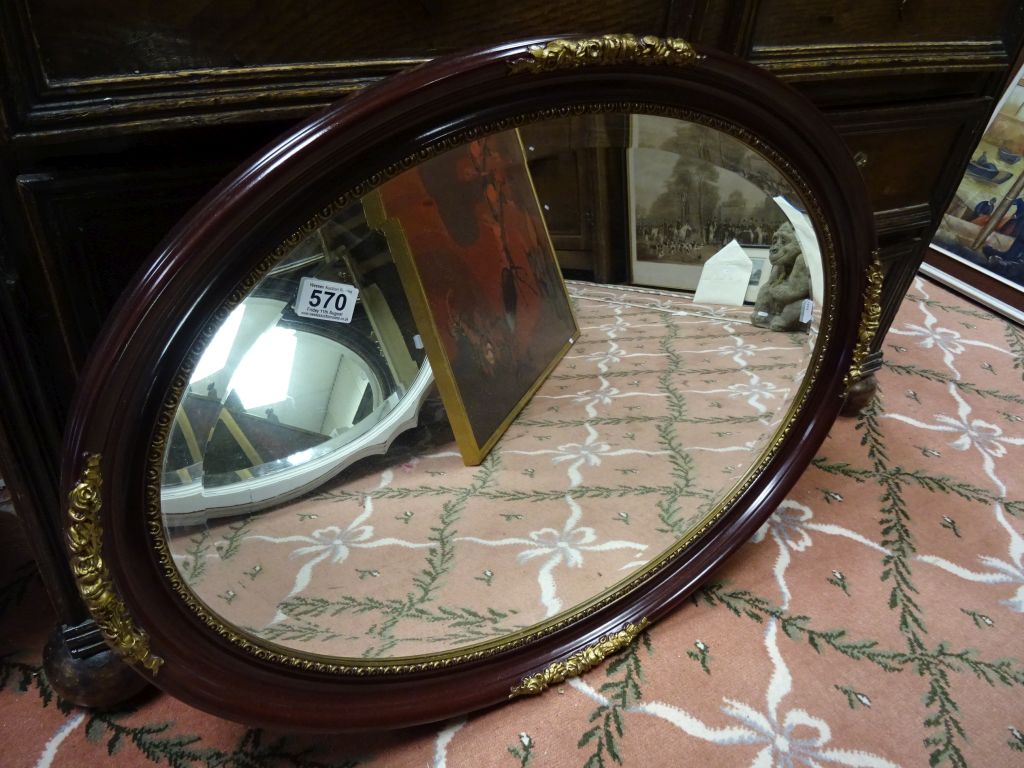 An antique style painted oval bevel edged wall mirror.