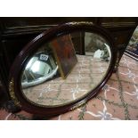 An antique style painted oval bevel edged wall mirror.