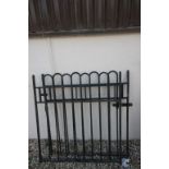 A pair of wrought iron gates painted black