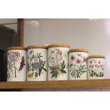 Five Portmeirion Botanic Garden pattern storage jars with wooden lids