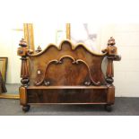 An antique continental flamed mahogany foot board of classical design.