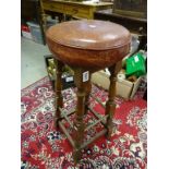 A mid 20th century oak bar stool with leather top.