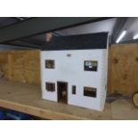 Wooden dolls house with bay window, wall paper interior, curtains and stairs. Includes four dolls,