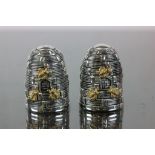 A pair of Silver plated condiments in the form of bee hives