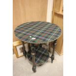 A 19th century tartan covered two tier centre table with ebonised and gilt legs