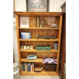 A 20th century pine freestanding bookcase with panelled back raised on a plinth base.