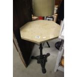 A composite marble topped octagonal pub style table with cast iron base.