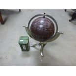 Contemporary globe on stand and a vintage tin with thermometer