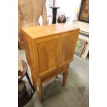 A Heals style light oak and pine cabinet with single drawer below raised on chamfered legs.