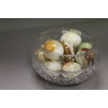 Cut glass bowl with approx twelve Onyx stone eggs