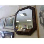 An art deco octagonal oak framed wall mirror .