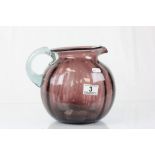 Large purple glass water jug with clear handle and pontil mark to base