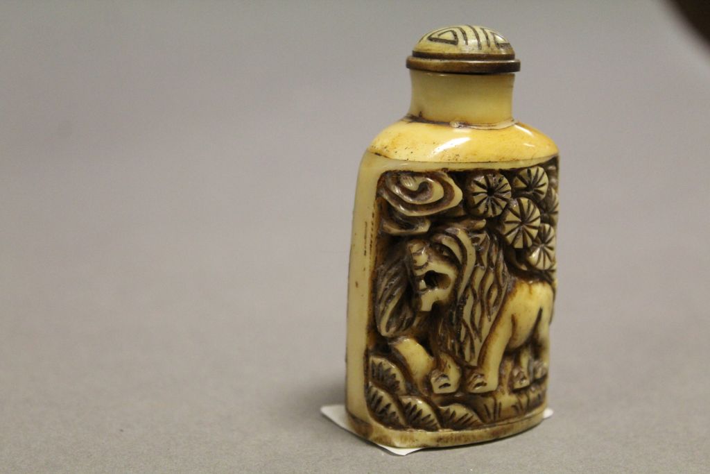 Bone snuff bottle with carved lions to sides