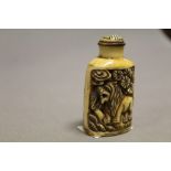 Bone snuff bottle with carved lions to sides