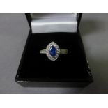 An 18ct white gold lozenge shaped sapphire and diamond ring of 85 points