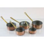Set of Four Small Copper Saucepans with Brass Handles plus a similar pan