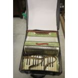 A German Tonella piano accordion with green marble effect finish in original case