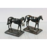 A pair of metal horses on stands