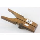 A vintage wooden folding boot jack