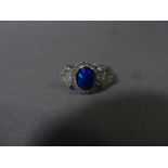 A silver, cz and blue opal ring