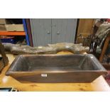 An antique cherry wood dough trough